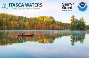 image of pristine calm lake during fall with a single canoeist paddling across the lake